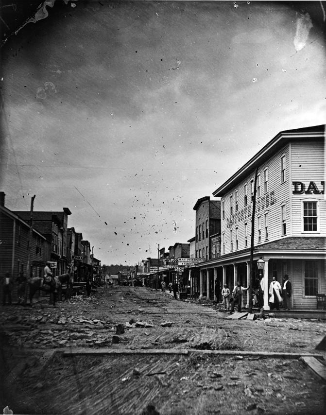 Photo from 1865 looking north up Holmden Street. Note the plank sidewalks and muddy conditions